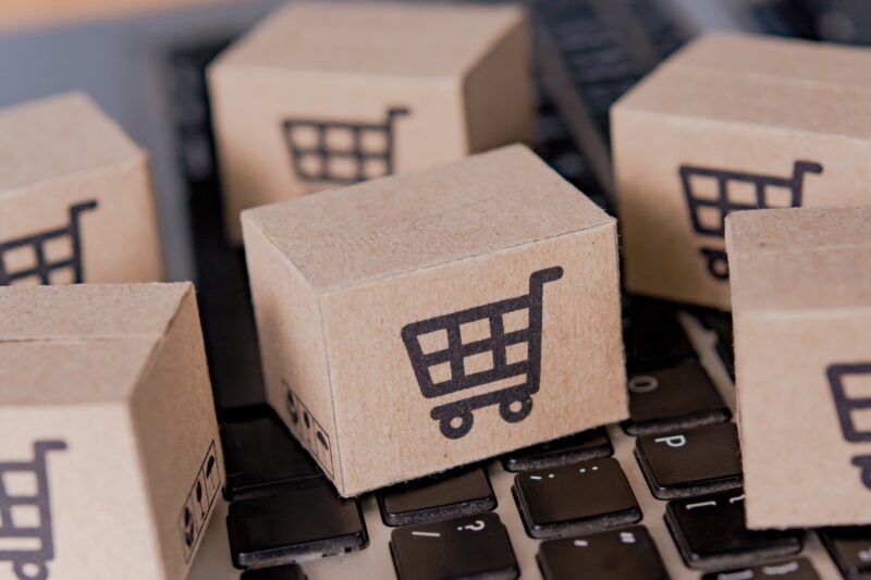 Cardboard box with a shopping cart logo on laptop keyboard. Shopping service on The online web.