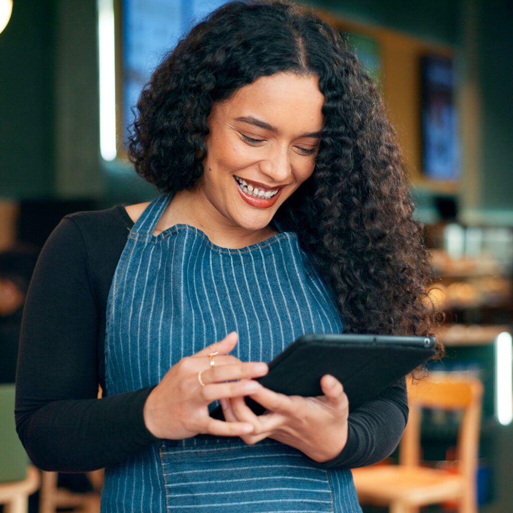 Coffee shop, happy waitress and tablet for restaurant sales, online management or reading customer