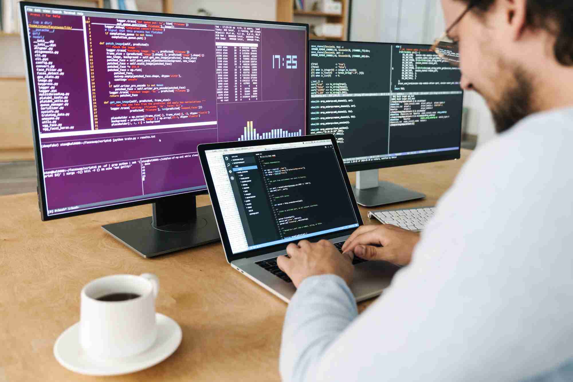 What are the best and free WYSIWYG HTML Editors? cropped image of man typing on keyboard while working with computers