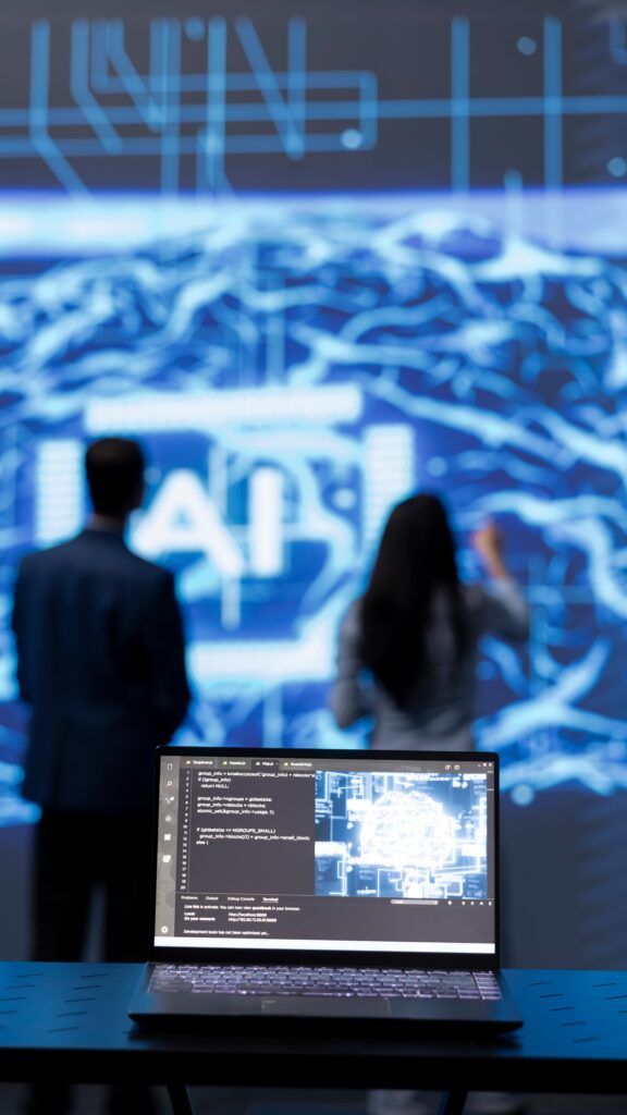 Focus on complex AI brain models being analyzed on laptop by developers
