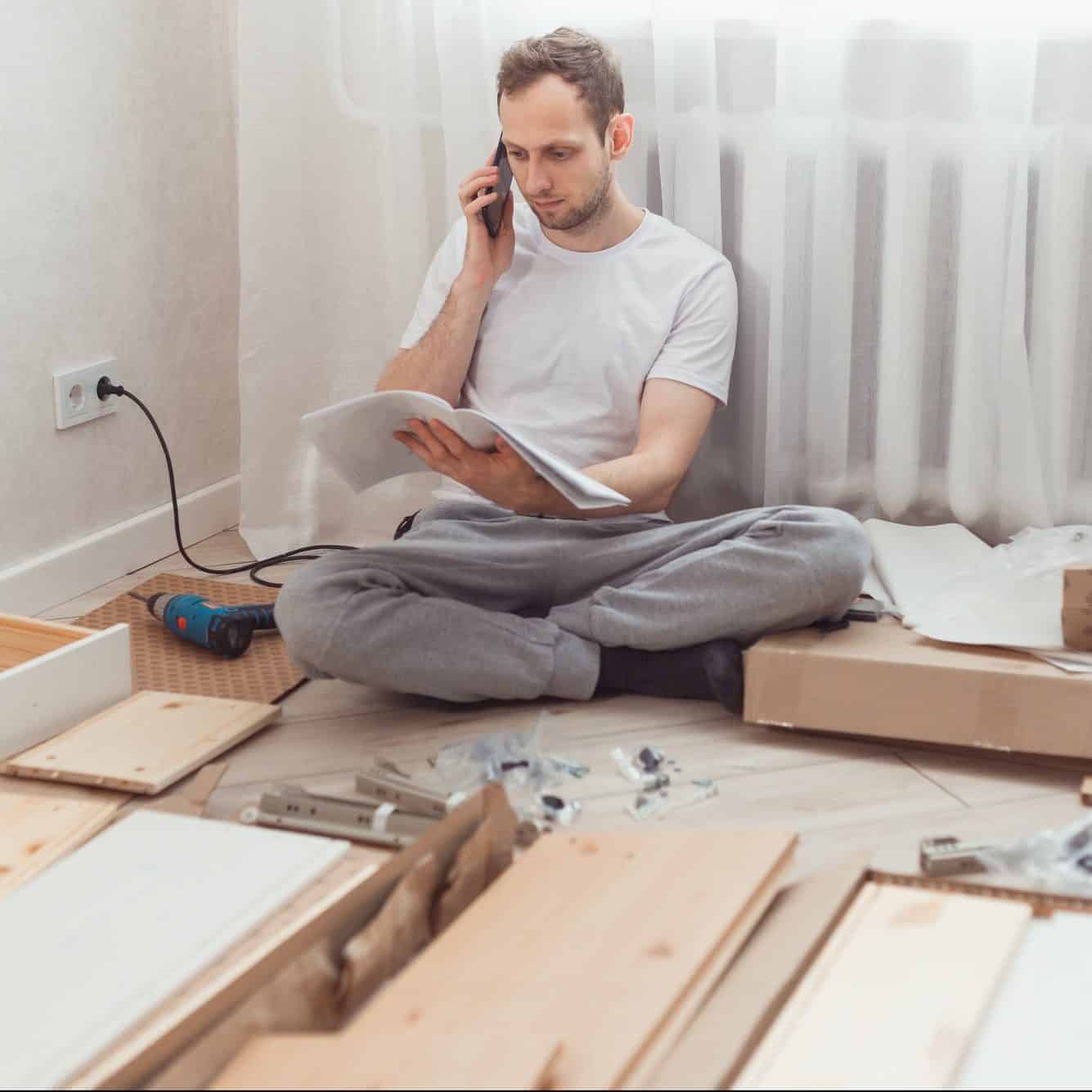 Customer Support & Customer Retention man customer calls to help center at home during assembling new furniture calling for a master e1629950548776