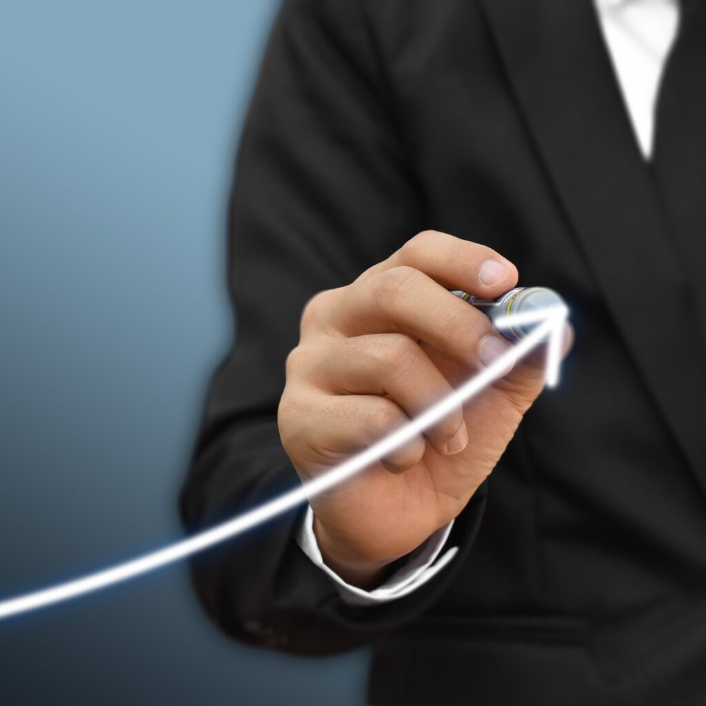 Businessman drawing arrow on screen graph corporate future growth plan
