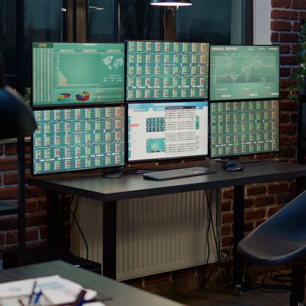 Empty office with stock market prices changing on multiple monitors