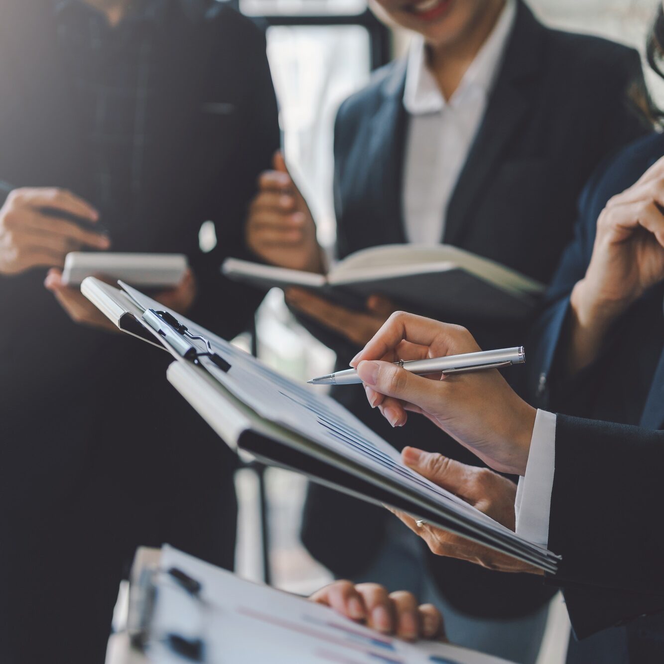 Group of business people stand together to discuss marketing plan. Sales Strategy