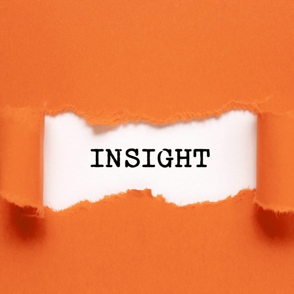 The word Insight appearing behind torn orange paper.