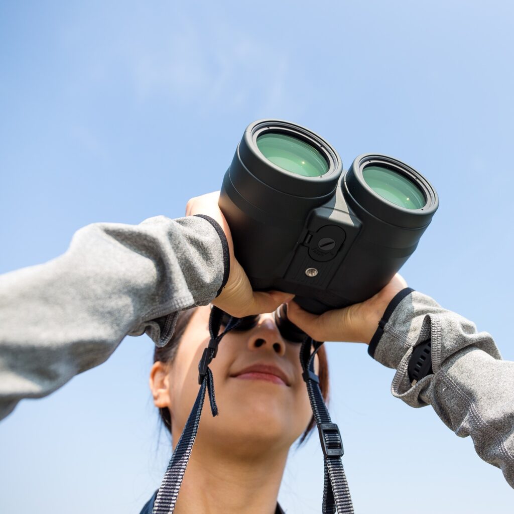Woman looking though binocular