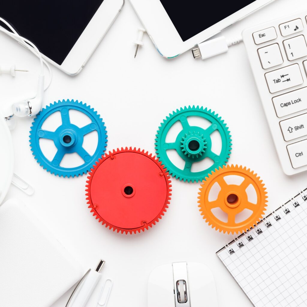 workflow and teamwork concepts with colorful gears and different gadgets